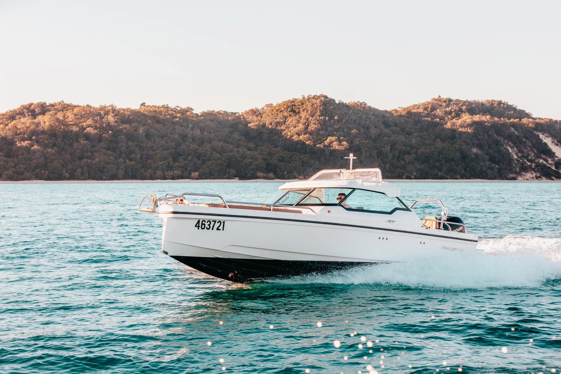 Sea La Vie cruising past a bushland shoreline on Moreton Bay