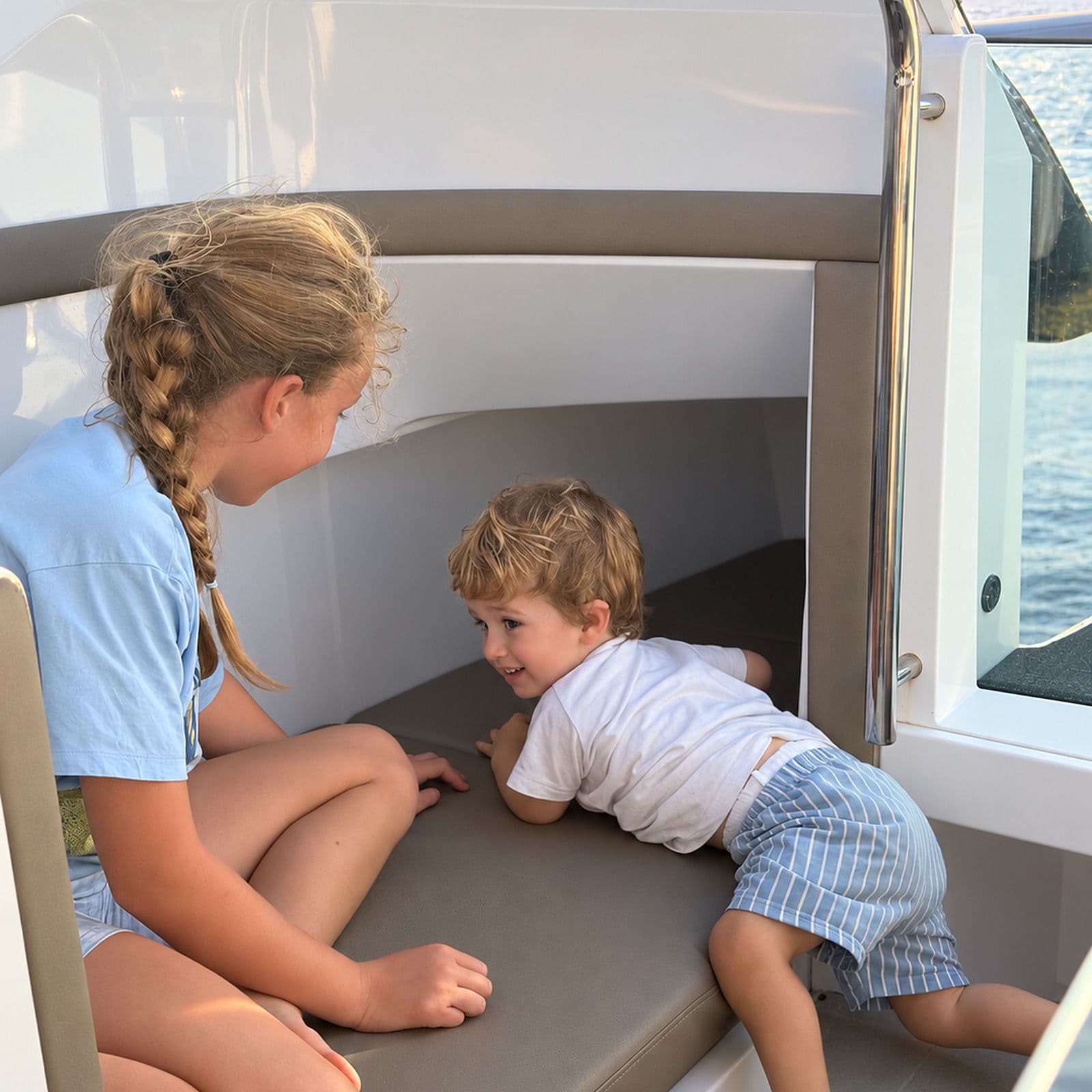 A brother and sister playing in the boat’s cabin