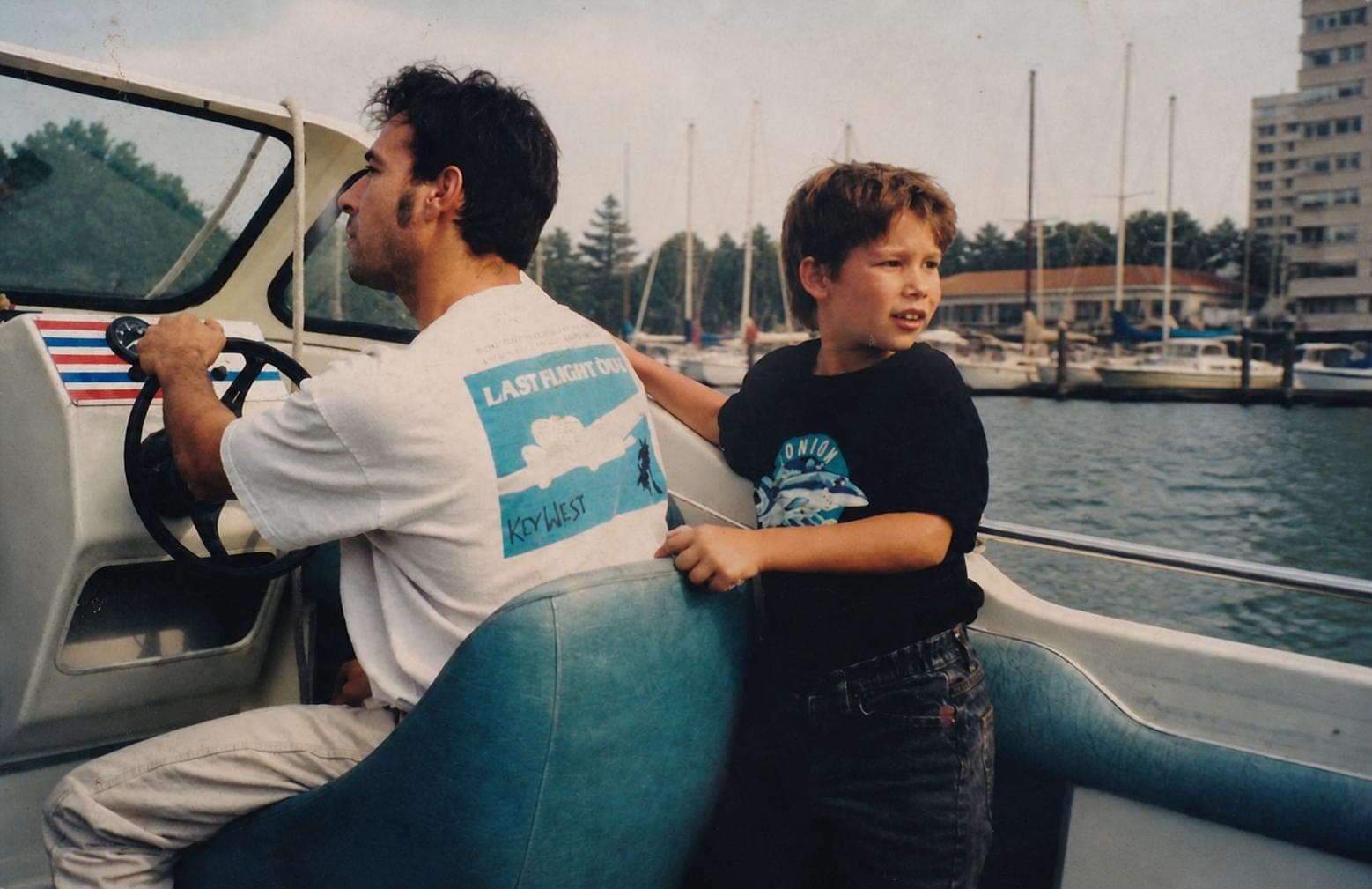 Around 1996 — young Jeremy behind his father at the helm