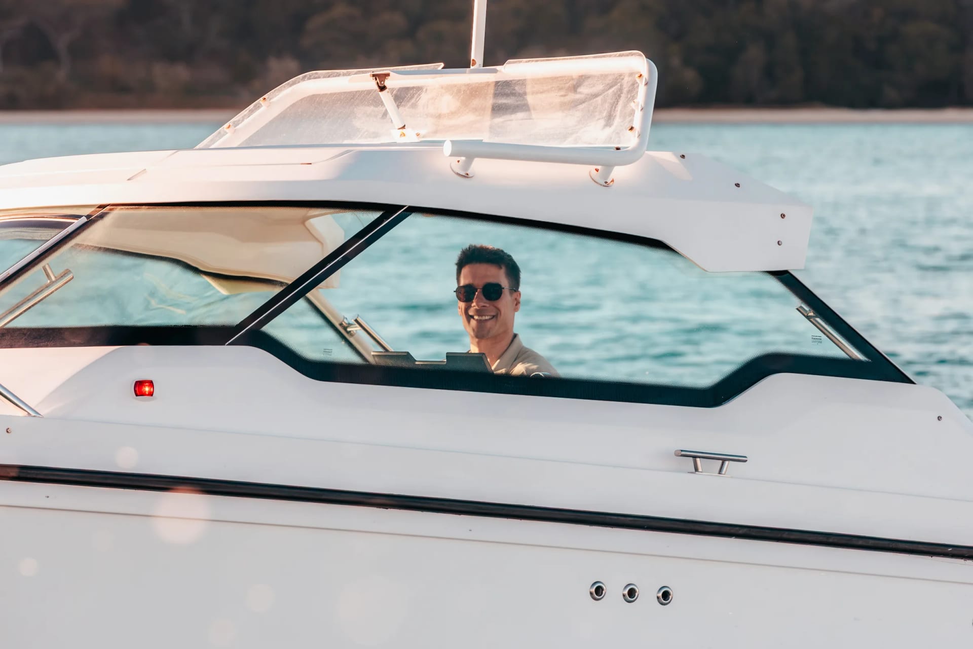 Captain Jeremy at the helm of Sea La Vie, seen through the windscreen