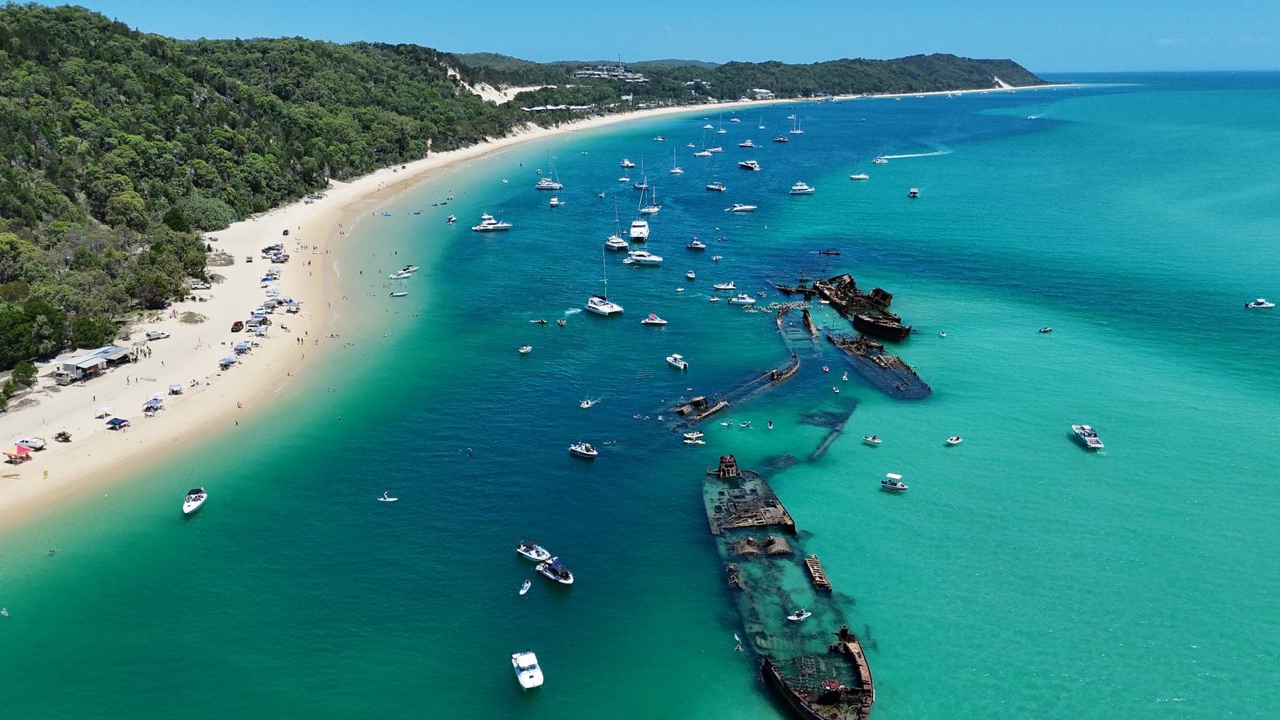 Aerial view of the Tangalooma Wrecks and the anchored fleet in turquoise water off Moreton Island