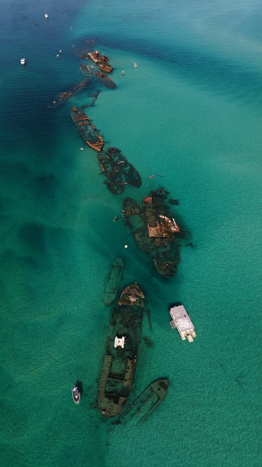 Aerial view of the Tangalooma Wrecks and the anchored fleet in turquoise water off Moreton Island